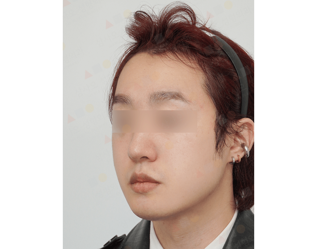 Person with headband and earrings facing left.