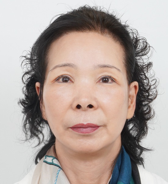 Portrait of a woman with curly hair.